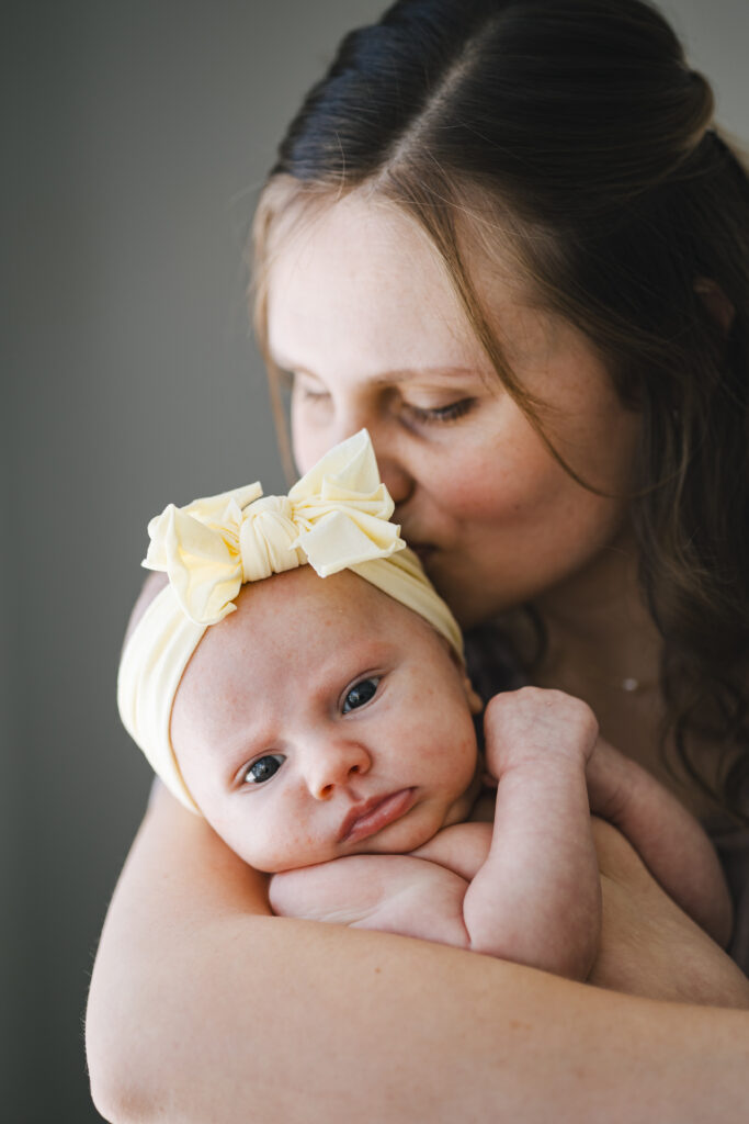 Niagara birth and postpartum doula kissing newborn baby