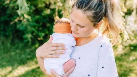 postpartum and doula mom holding newborn baby