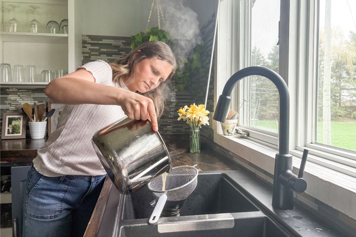 pouring bone broth into jars